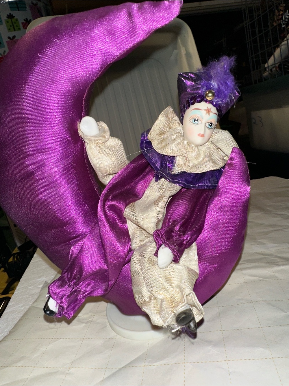 Vintage musical porcelain jester doll on moon pillow